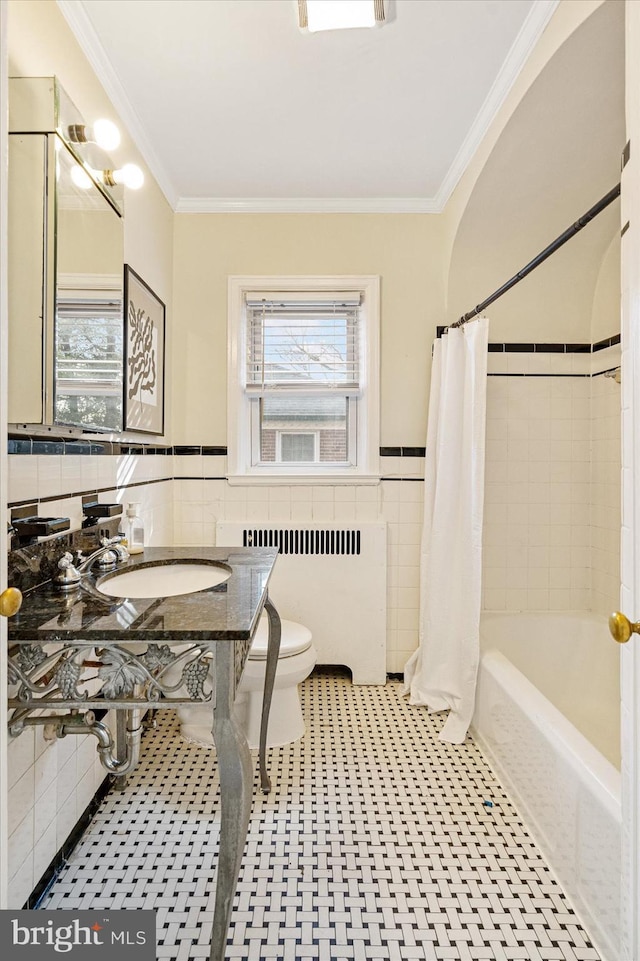 841 E Belvedere Ave E, Baltimore, MD 21212 - full bath featuring radiator, tile walls, plenty of natural light, toilet, and ornamental molding