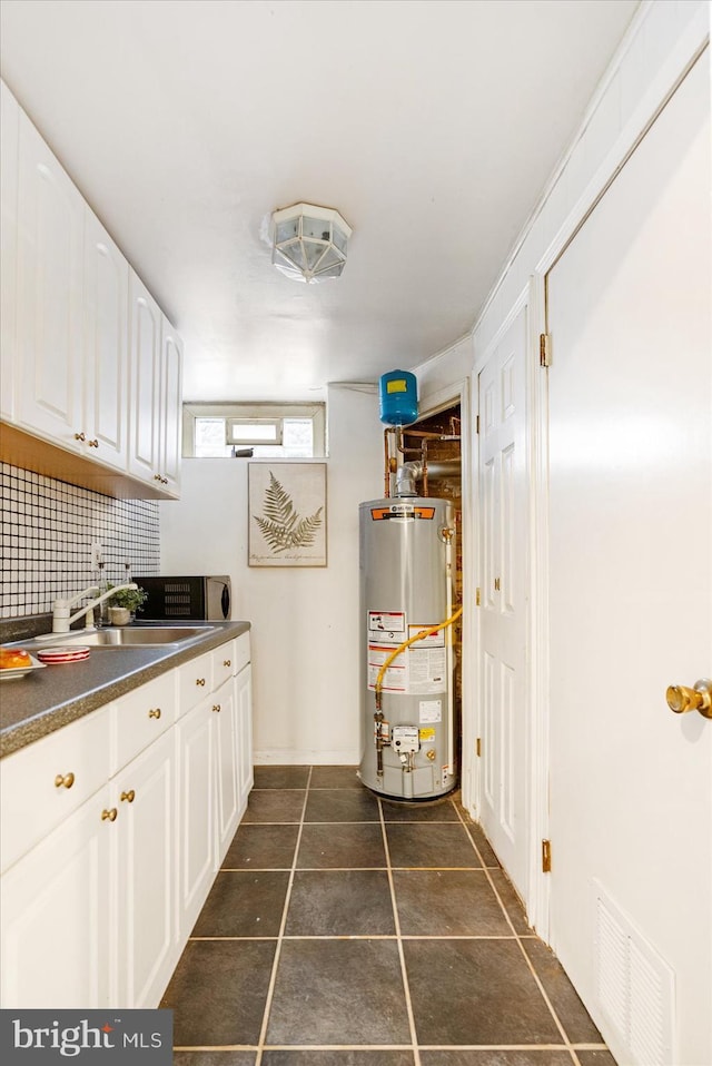 841 E Belvedere Ave E, Baltimore, MD 21212 - laundry room featuring water heater and a sink