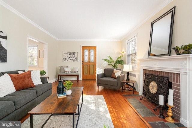 841 E Belvedere Ave E, Baltimore, MD 21212 - living room featuring wood finished floors, crown molding, and a brick fireplace