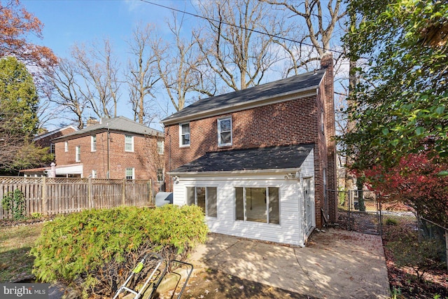 841 E Belvedere Ave E, Baltimore, MD 21212 - back of property with a chimney, brick siding, and a patio