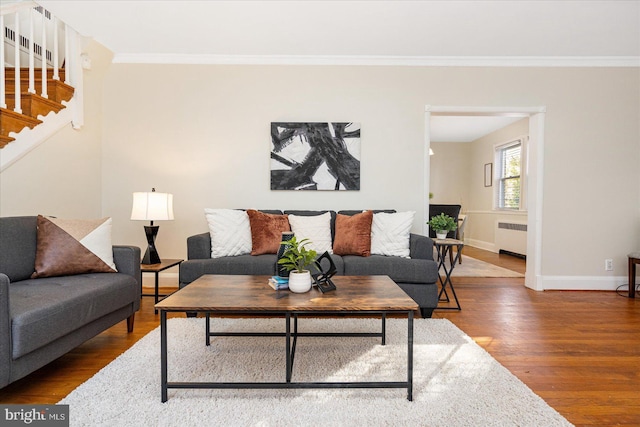 841 E Belvedere Ave E, Baltimore, MD 21212 - living room with radiator heating unit, wood finished floors, ornamental molding, baseboards, and stairway