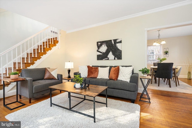 841 E Belvedere Ave E, Baltimore, MD 21212 - living area featuring stairway, wood finished floors, ornamental molding, a chandelier, and baseboards