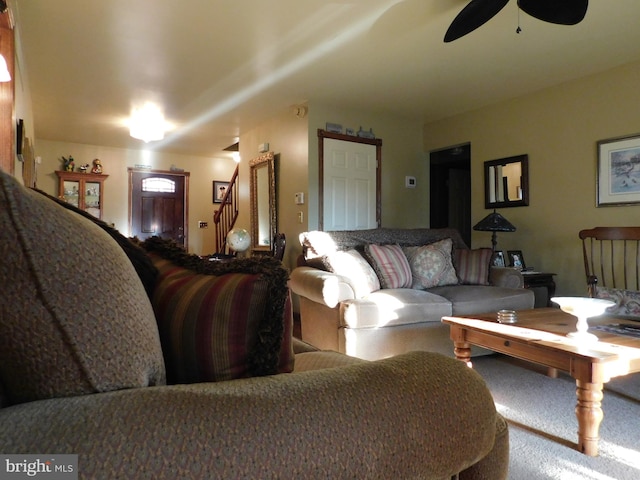 carpeted living room featuring ceiling fan