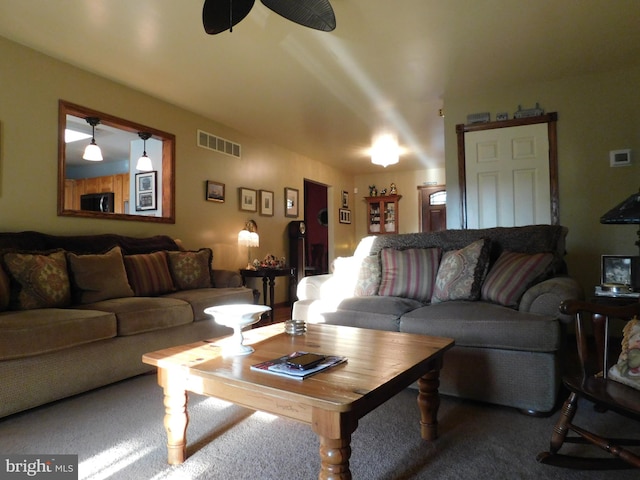 living room with carpet and ceiling fan