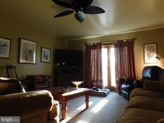 carpeted living room with ceiling fan