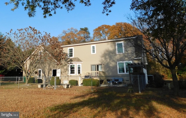 rear view of house with a yard