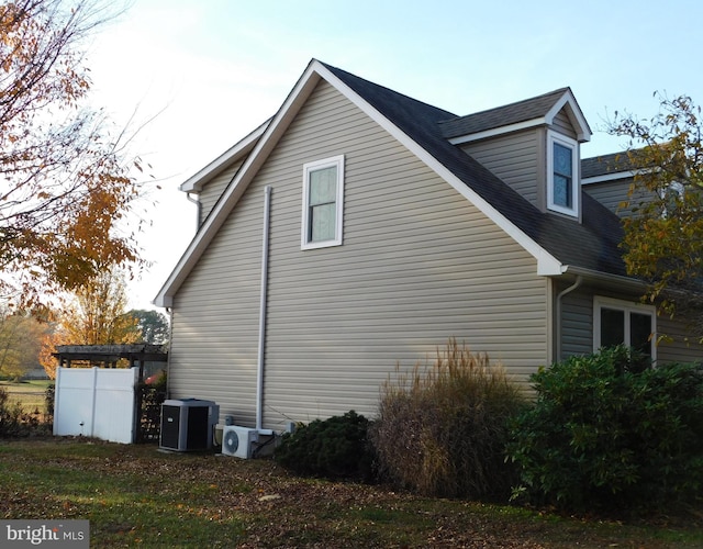 view of side of property featuring ac unit and central AC