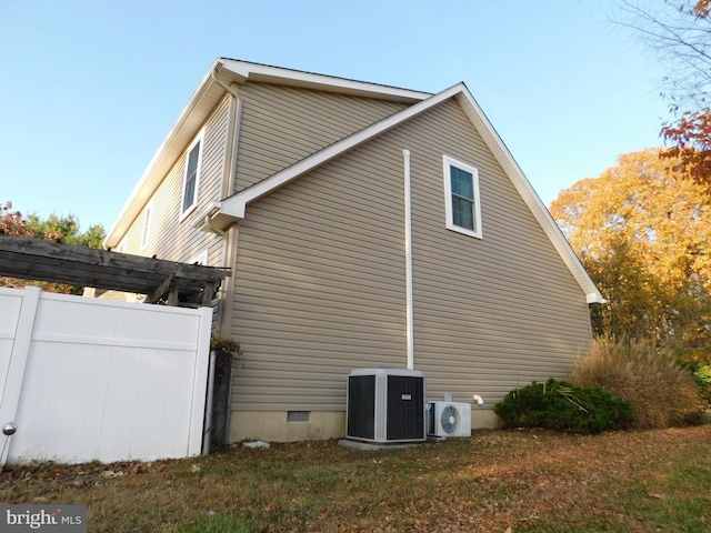 view of side of property featuring ac unit and central AC unit