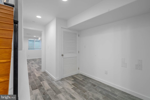 corridor with hardwood / wood-style floors