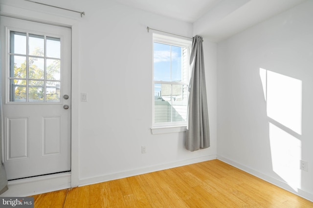 entrance foyer with hardwood / wood-style floors and a healthy amount of sunlight