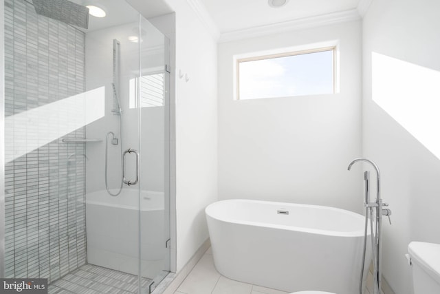 bathroom featuring tile patterned floors, toilet, ornamental molding, and plus walk in shower