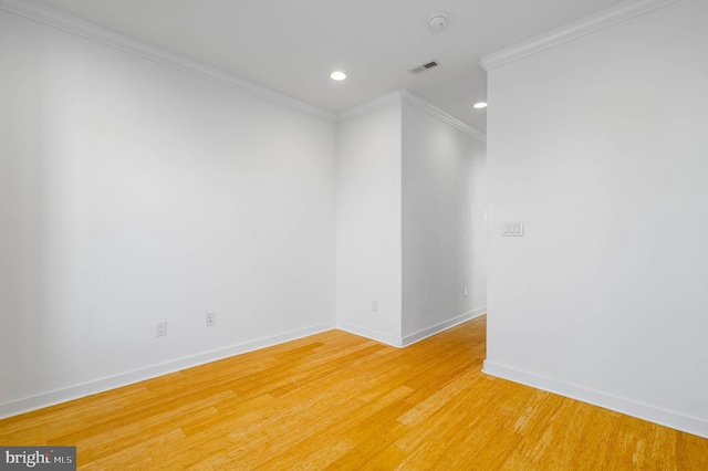 unfurnished room with hardwood / wood-style flooring and ornamental molding