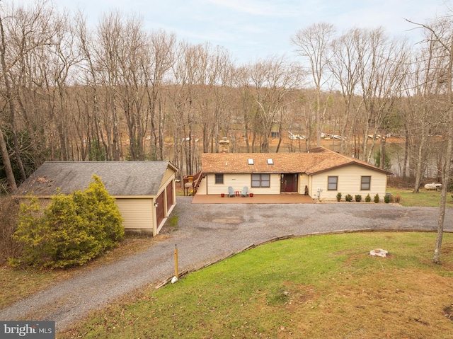 view of front of home featuring a front yard and a wooden deck