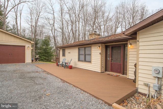 doorway to property featuring a garage and a deck