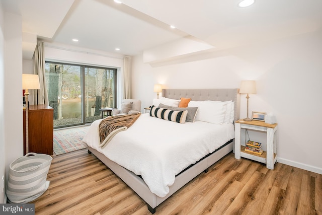 bedroom featuring access to exterior and wood-type flooring