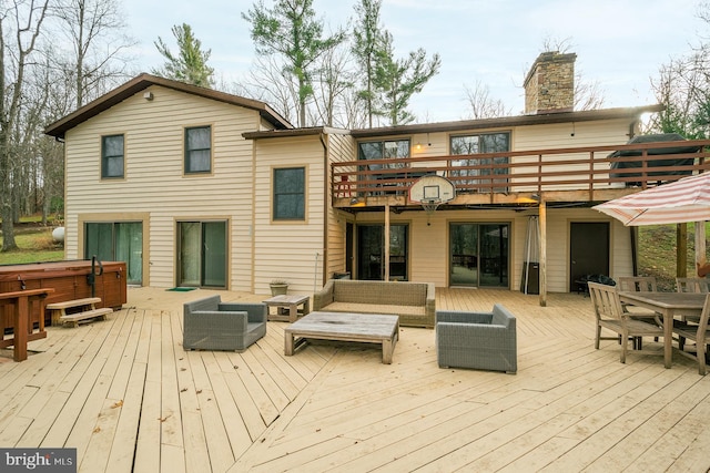 deck featuring an outdoor hangout area and a hot tub