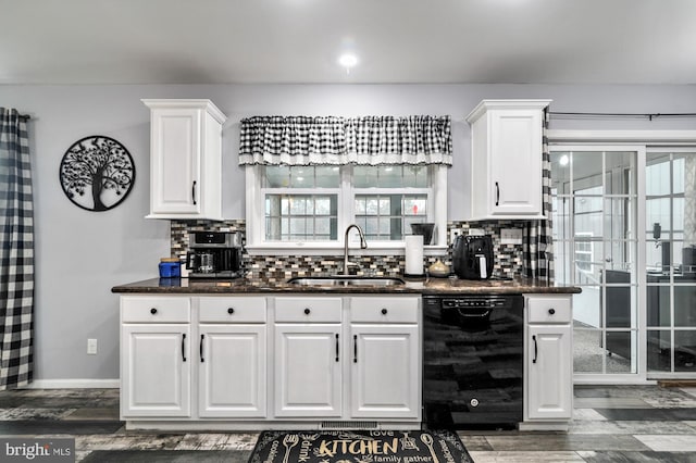 kitchen featuring white cabinets, backsplash, sink, and black dishwasher