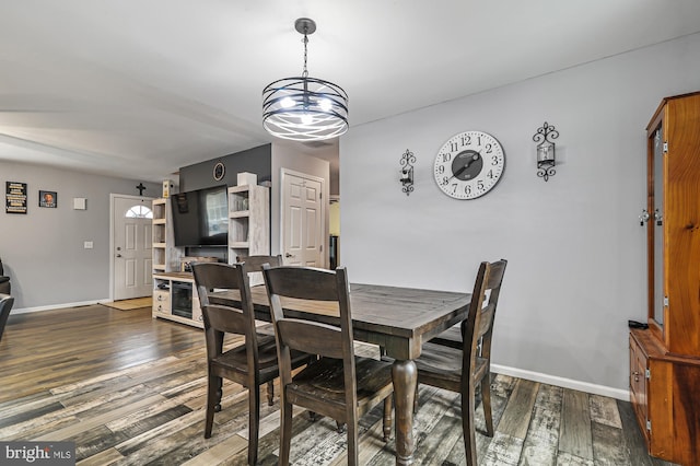 dining area with dark hardwood / wood-style flooring