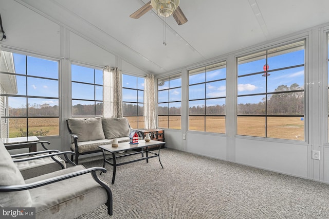 sunroom / solarium featuring ceiling fan, lofted ceiling, and a wealth of natural light