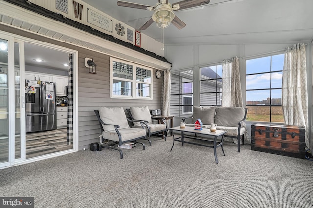 sunroom featuring ceiling fan and lofted ceiling