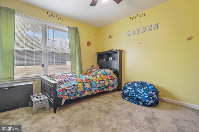 carpeted bedroom with multiple windows and ceiling fan