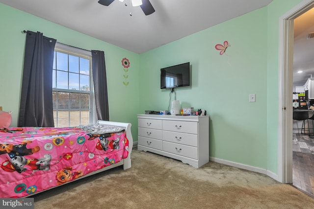 bedroom featuring ceiling fan and light carpet