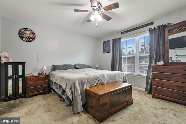 bedroom with ceiling fan and light colored carpet