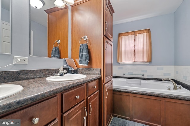 bathroom with backsplash, a bathtub, and vanity