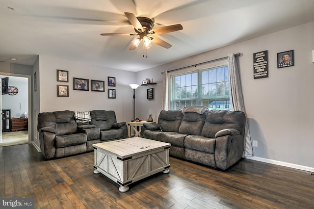 living room featuring ceiling fan and dark hardwood / wood-style floors