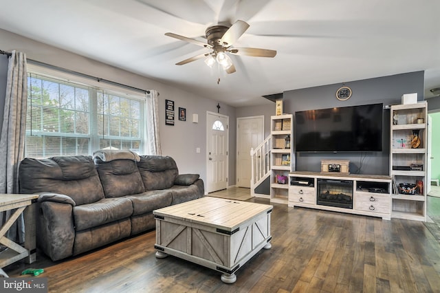 living room featuring dark hardwood / wood-style floors and ceiling fan