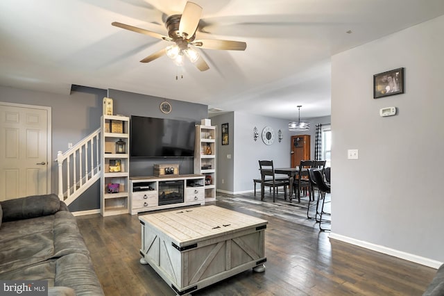 living room featuring dark hardwood / wood-style flooring and ceiling fan