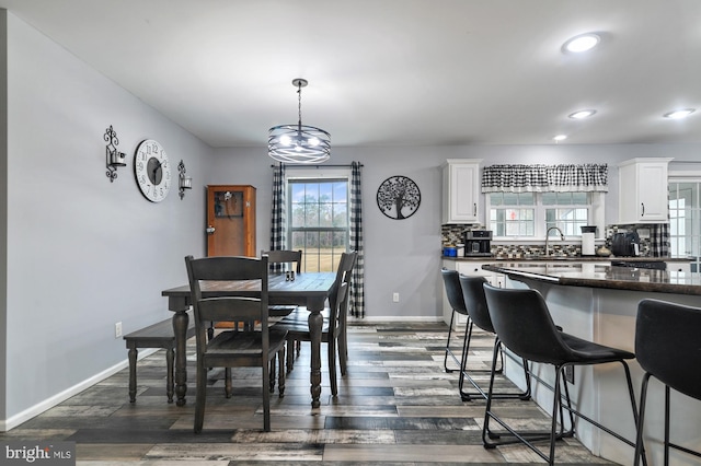 dining room featuring a chandelier, dark hardwood / wood-style flooring, and sink