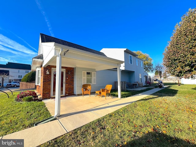 view of property exterior with a lawn and covered porch