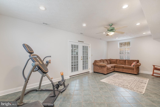 living room with ceiling fan, a textured ceiling, and french doors