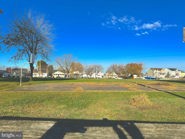 view of yard with basketball hoop