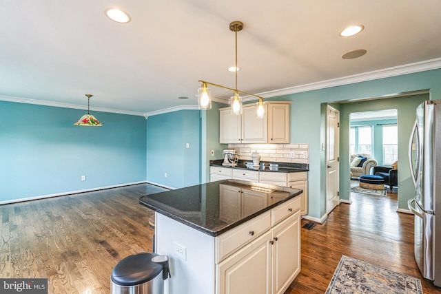 kitchen with stainless steel fridge, pendant lighting, dark hardwood / wood-style flooring, and crown molding