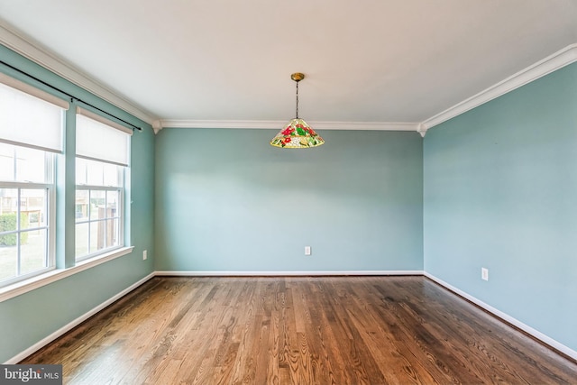 empty room featuring crown molding and hardwood / wood-style flooring