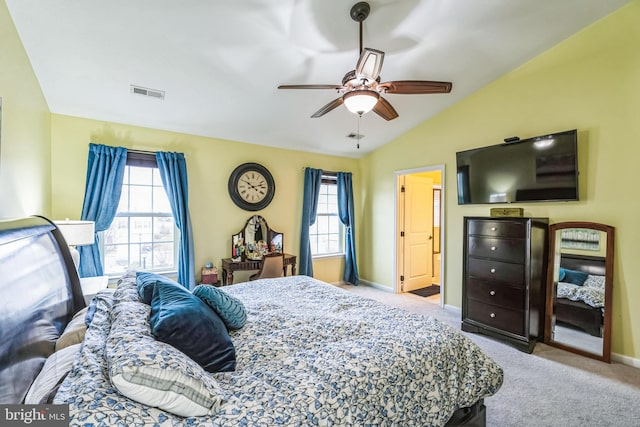 bedroom featuring ceiling fan, lofted ceiling, light carpet, and multiple windows