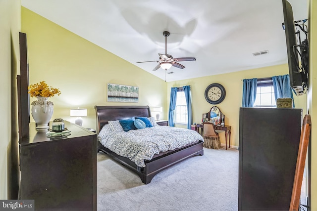 carpeted bedroom with ceiling fan and vaulted ceiling