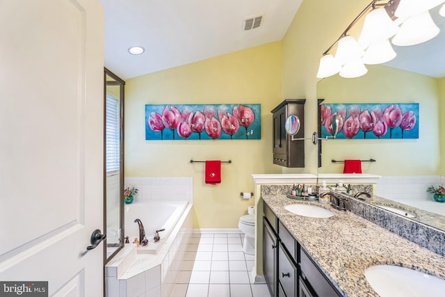 bathroom with vanity, vaulted ceiling, tile patterned flooring, toilet, and tiled bath