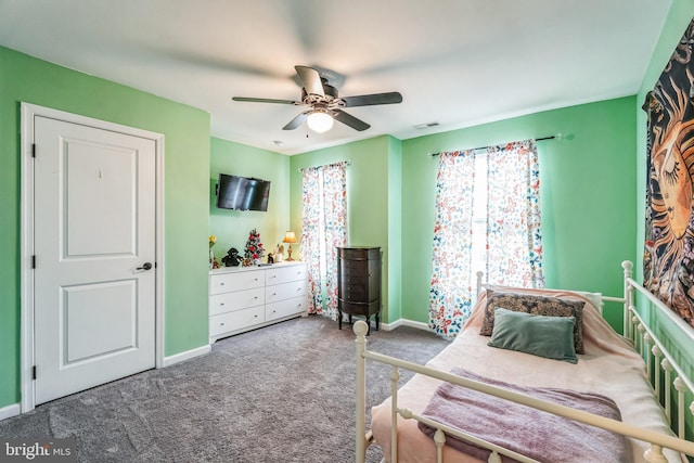 carpeted bedroom with multiple windows and ceiling fan