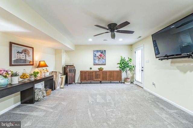 interior space featuring ceiling fan and light carpet