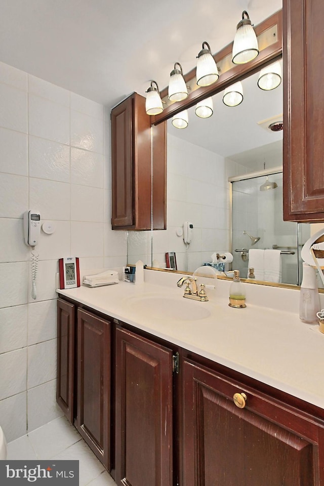 bathroom with tile walls, tile patterned floors, and vanity