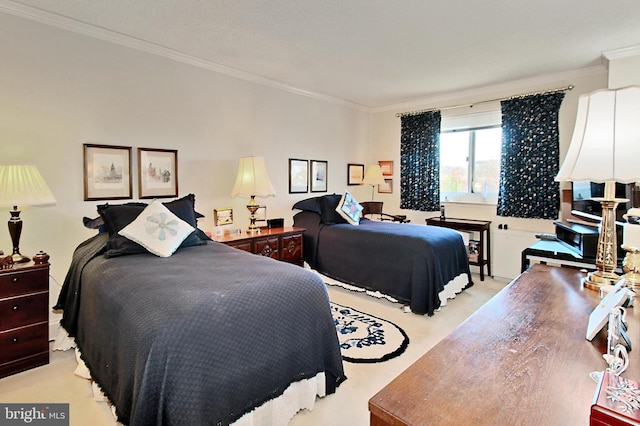 bedroom with ornamental molding and light carpet