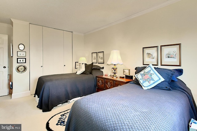 carpeted bedroom featuring a closet and ornamental molding