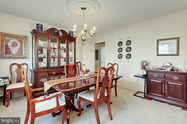 dining space featuring a textured ceiling, light carpet, ornamental molding, and an inviting chandelier