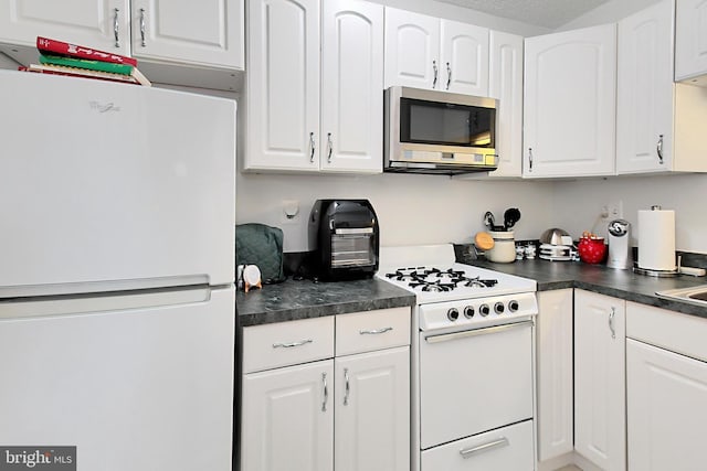 kitchen with white cabinetry and white appliances