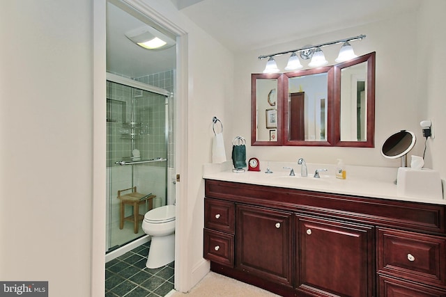 bathroom with toilet, a shower with shower door, and vanity