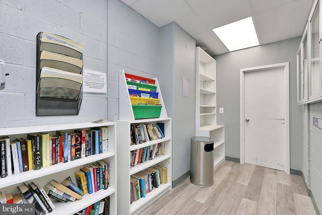 interior space featuring light hardwood / wood-style flooring and a drop ceiling