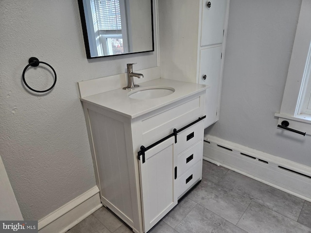 bathroom with vanity and a baseboard heating unit